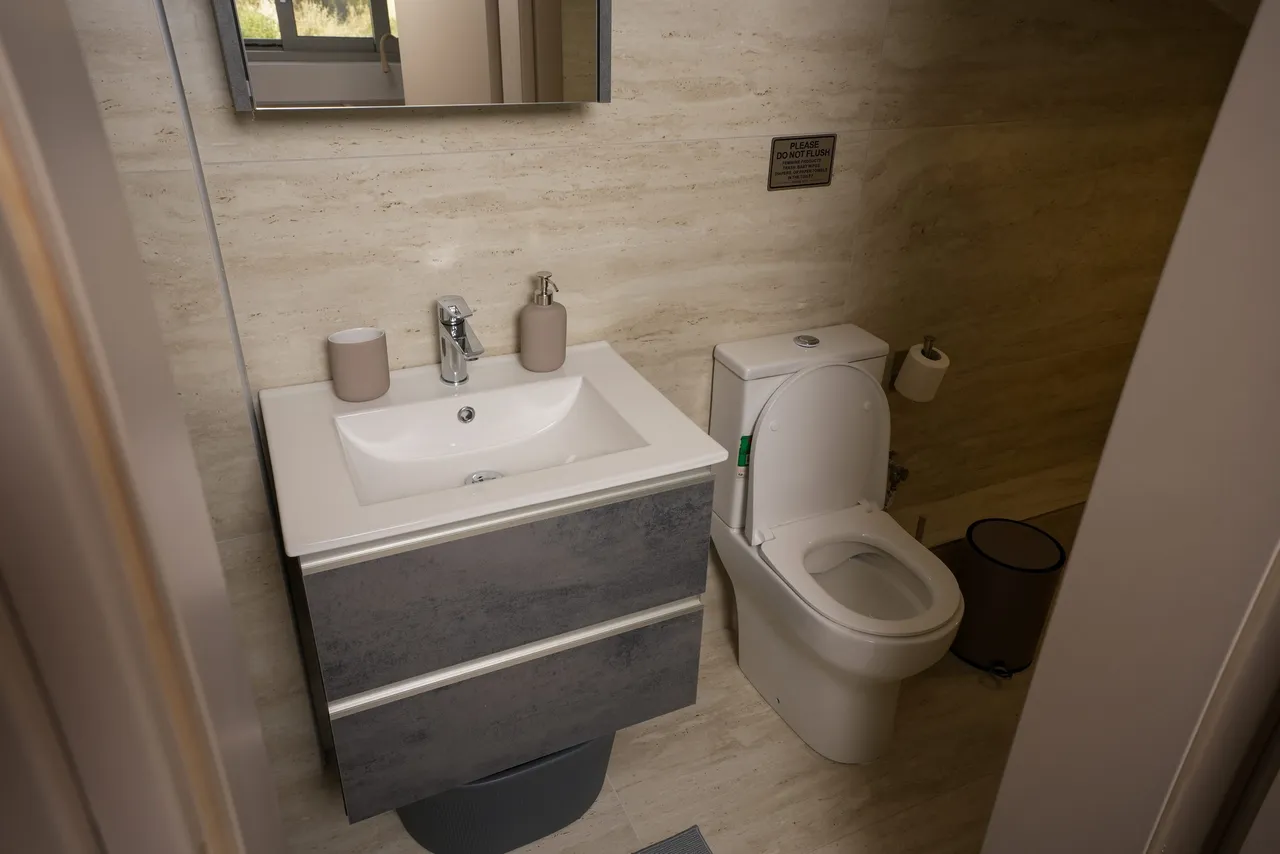 Bathroom one with stone surfaces and contemporary fittings