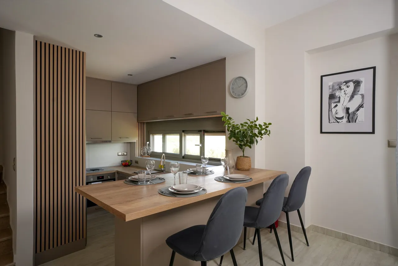 Open kitchen and dining table in warm neutral tones