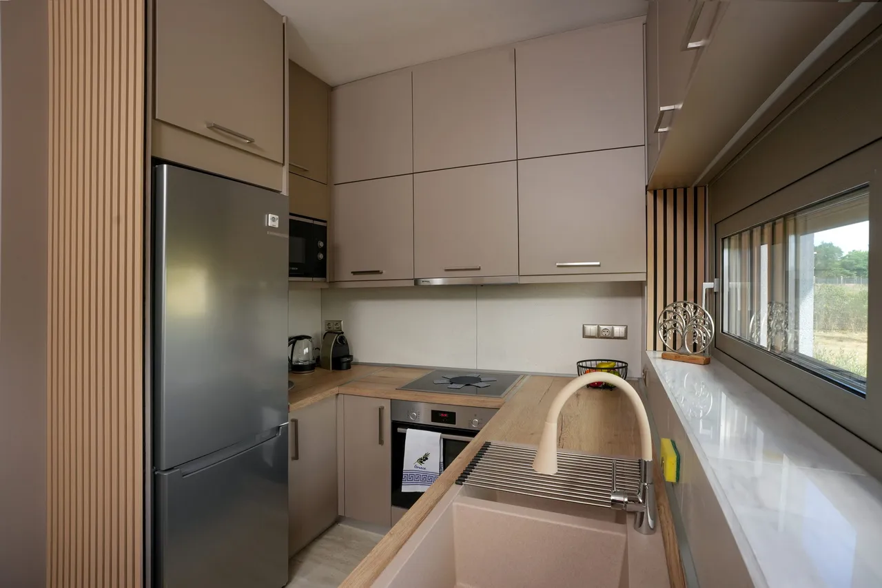 Full view of the taupe kitchen cabinetry