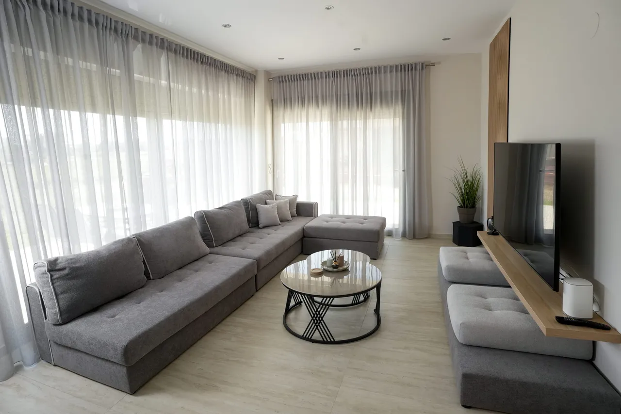 Salon framed by floor-to-ceiling sheer curtains
